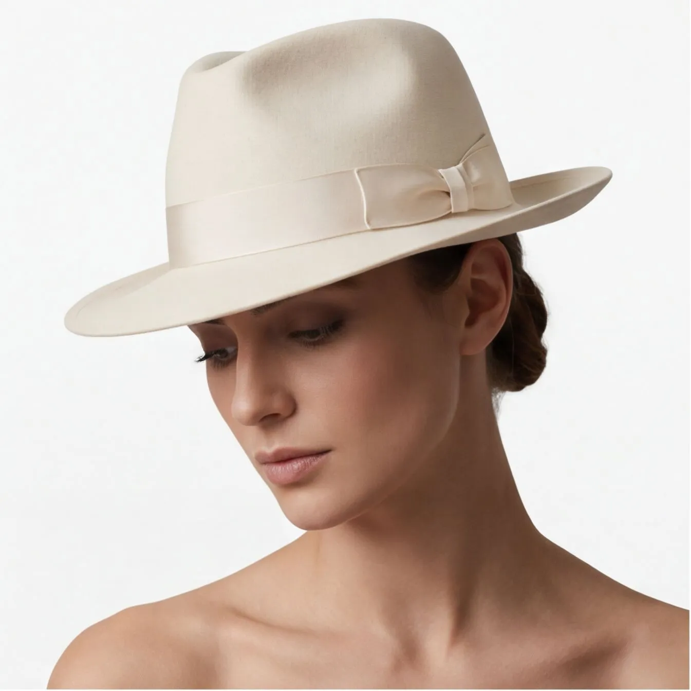 Cream felt fedora with bow on a model, consistent catalog styling