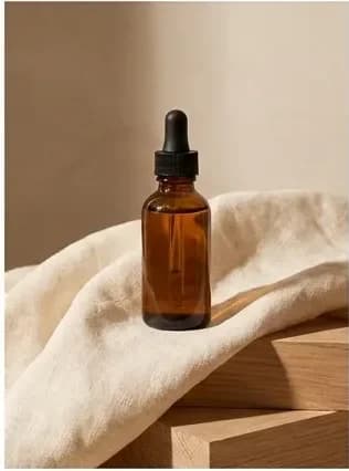 Amber bottle on cream linen