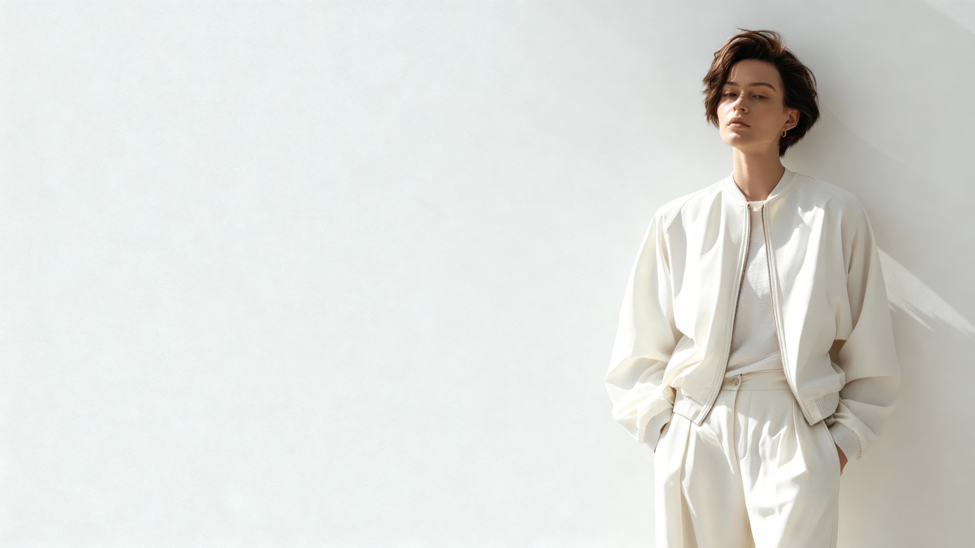 A photorealistic AI image of a gorgeous model posing by leaning on a wall and looking confidently into the camera.