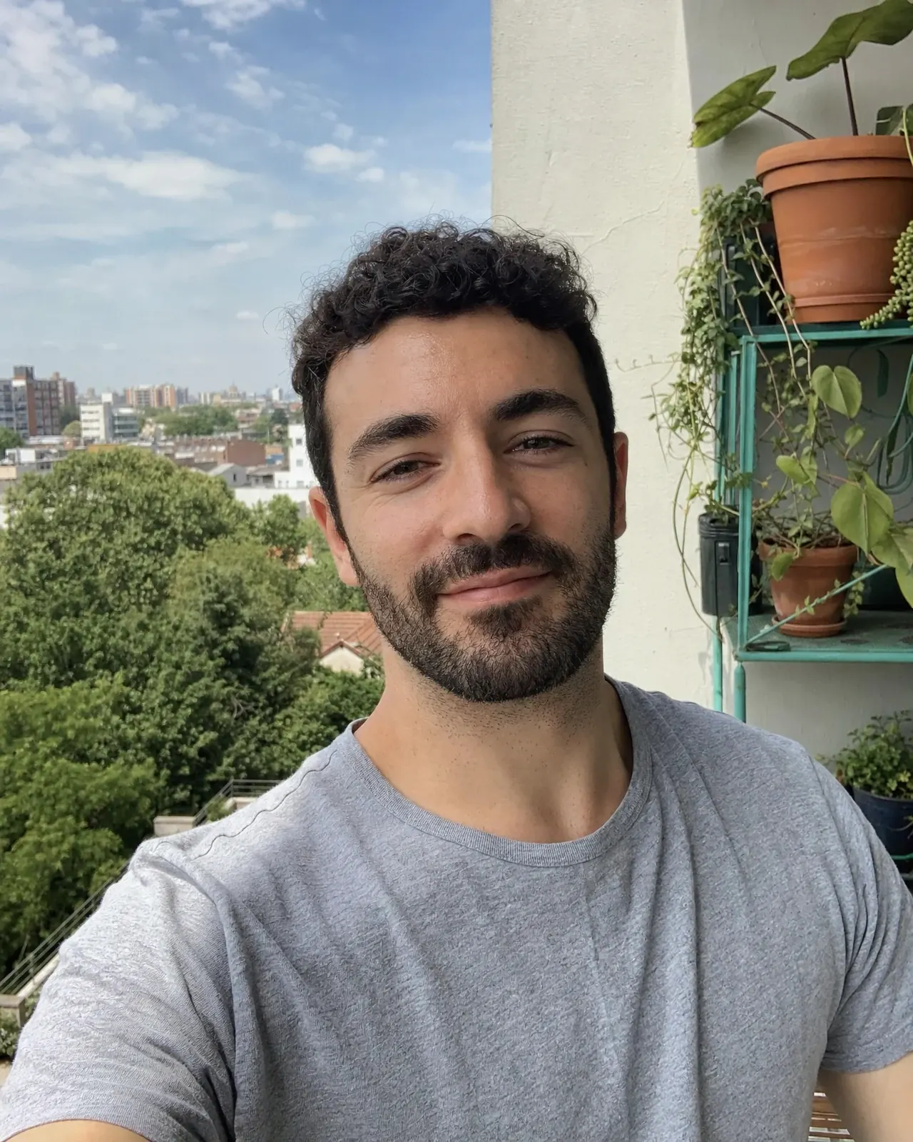 A casual phone photo of a man on a balcony, uploaded to create a custom AI fashion model.