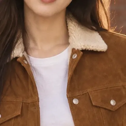 The same shearling collar and snap pockets, cropped from the photo of the AI fashion model wearing the jacket.