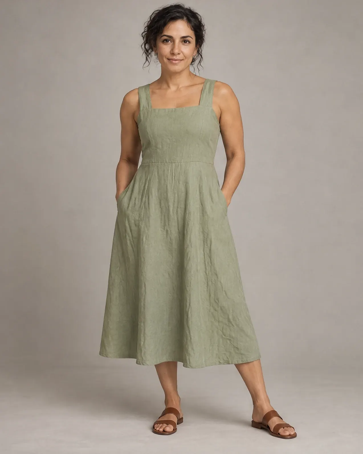 An athletic AI fashion model wears the same sage linen midi dress.