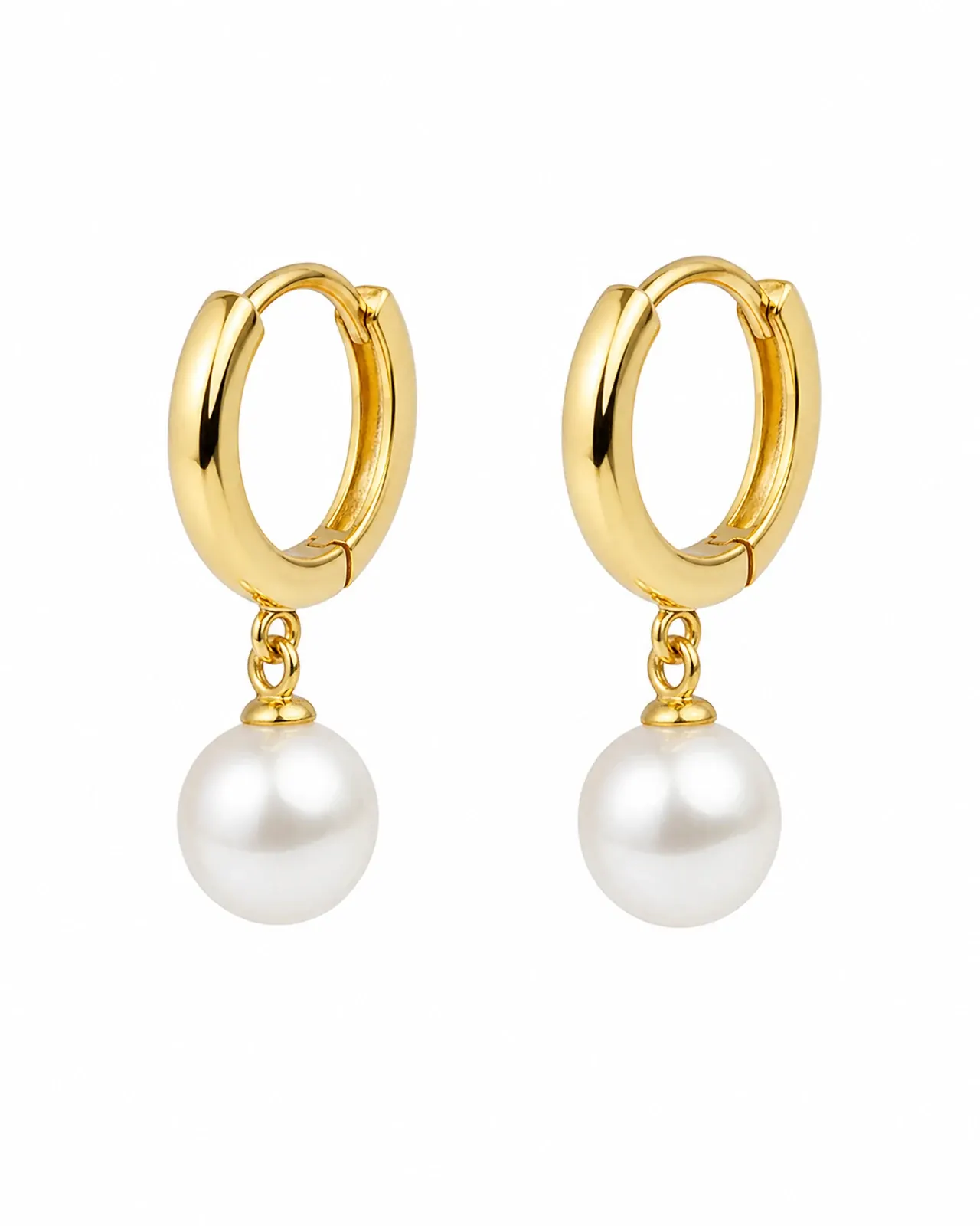 The packshot it was made from: the pair of gold huggie hoops with pearl drops on white.