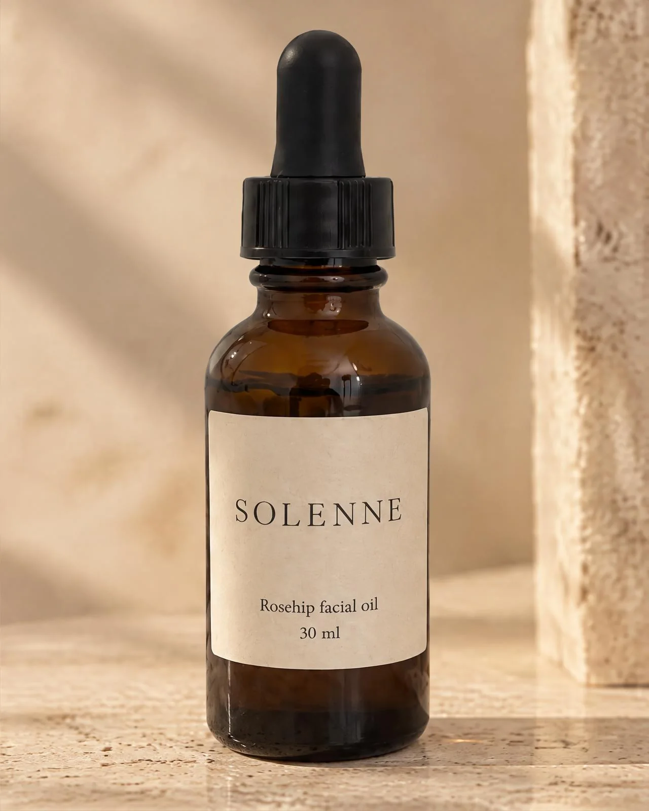 A close product photo of the rosehip oil bottle with its cream label in warm light.